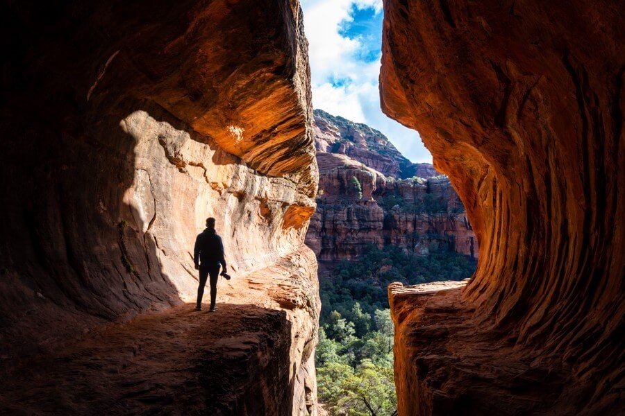 Silhouette of hiker with camera in Subway Cave Sedona