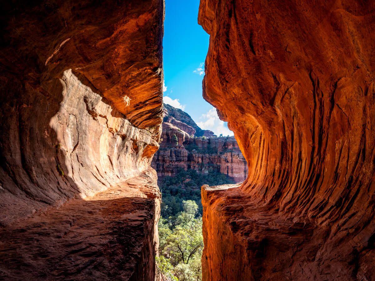 Subway Cave glowing orange on the Boynton Canyon Trail hike in Sedona Arizona one of the most photogenic caves and a very popular hiking route in Sedona