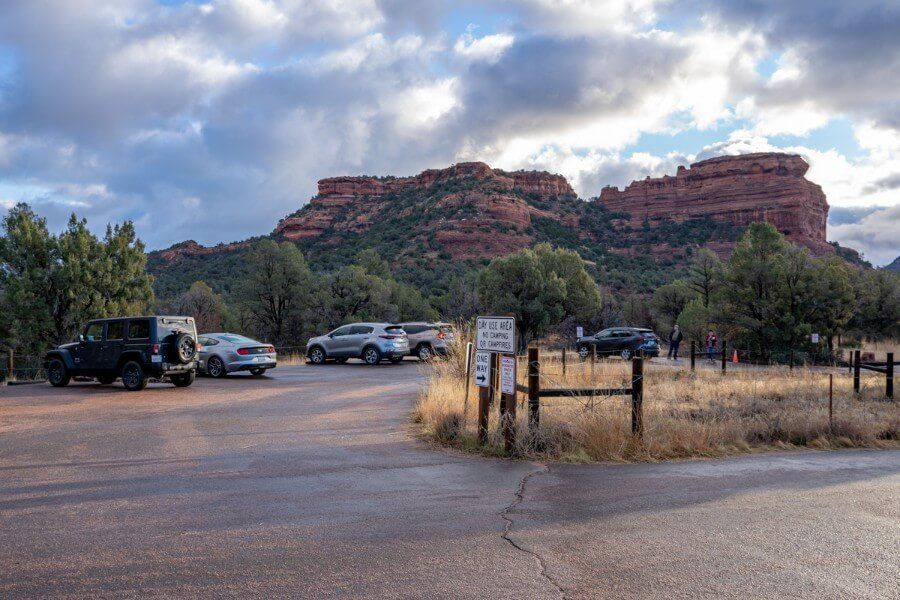 Boynton Canyon Trail Parking Lot cars and red rocks on cloudy day