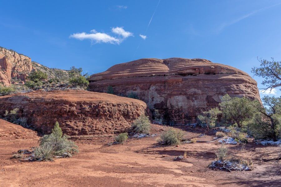 Rounded rock formations like stacked pancakes made of red sandstone with blue sky background