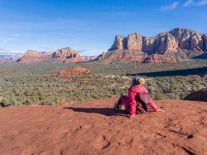 Hiking Bell Rock Courthouse Butte Loop Trail in Sedona Arizona sat looking at spectacular views half way up the Bell Rock climb on a sunny day in Winter one of best hikes in Sedona