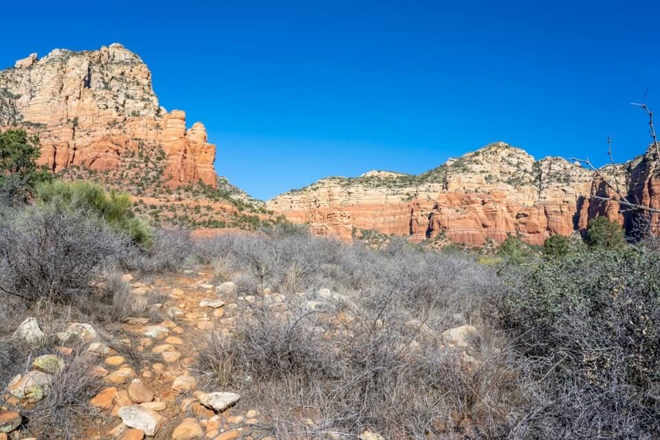 Hiking trail leading to Keyhole Cave in Sedona Arizona on a blue sky day