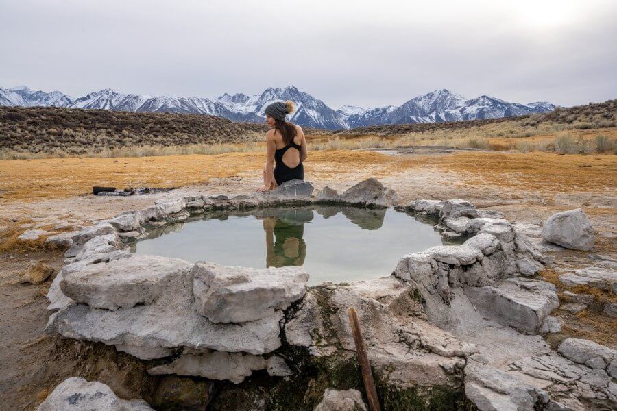 Hilltop hot spring with woman bathing