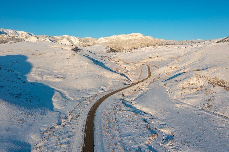 Snowy road leading into Yellowstone drone photo