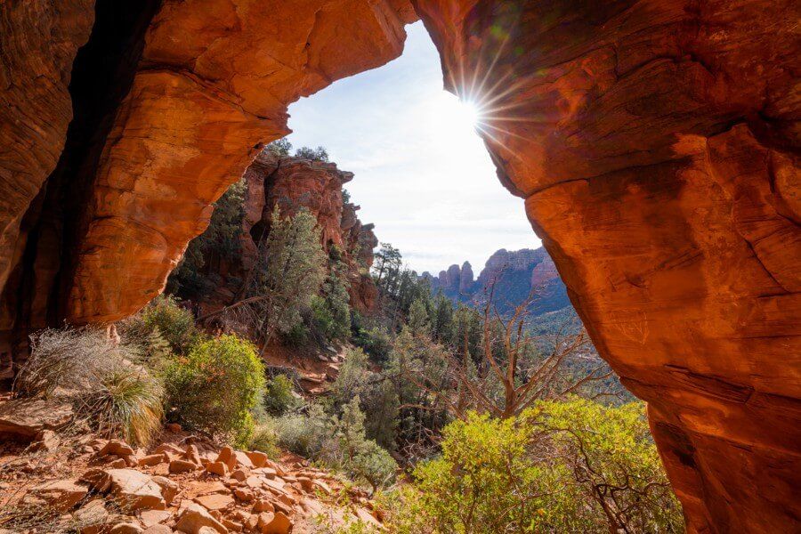 Starburst with the sun on red rock formation in Arizona