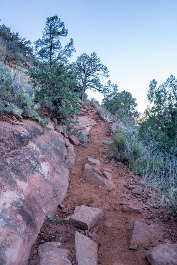 Long narrow section of hiking trail at sunrise leading up Doe Mountain in Sedona