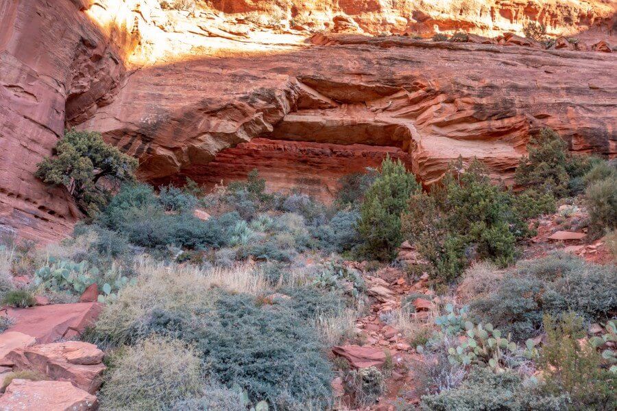 Fay Canyon Arch from below climbing a steep bank in sedona arizona