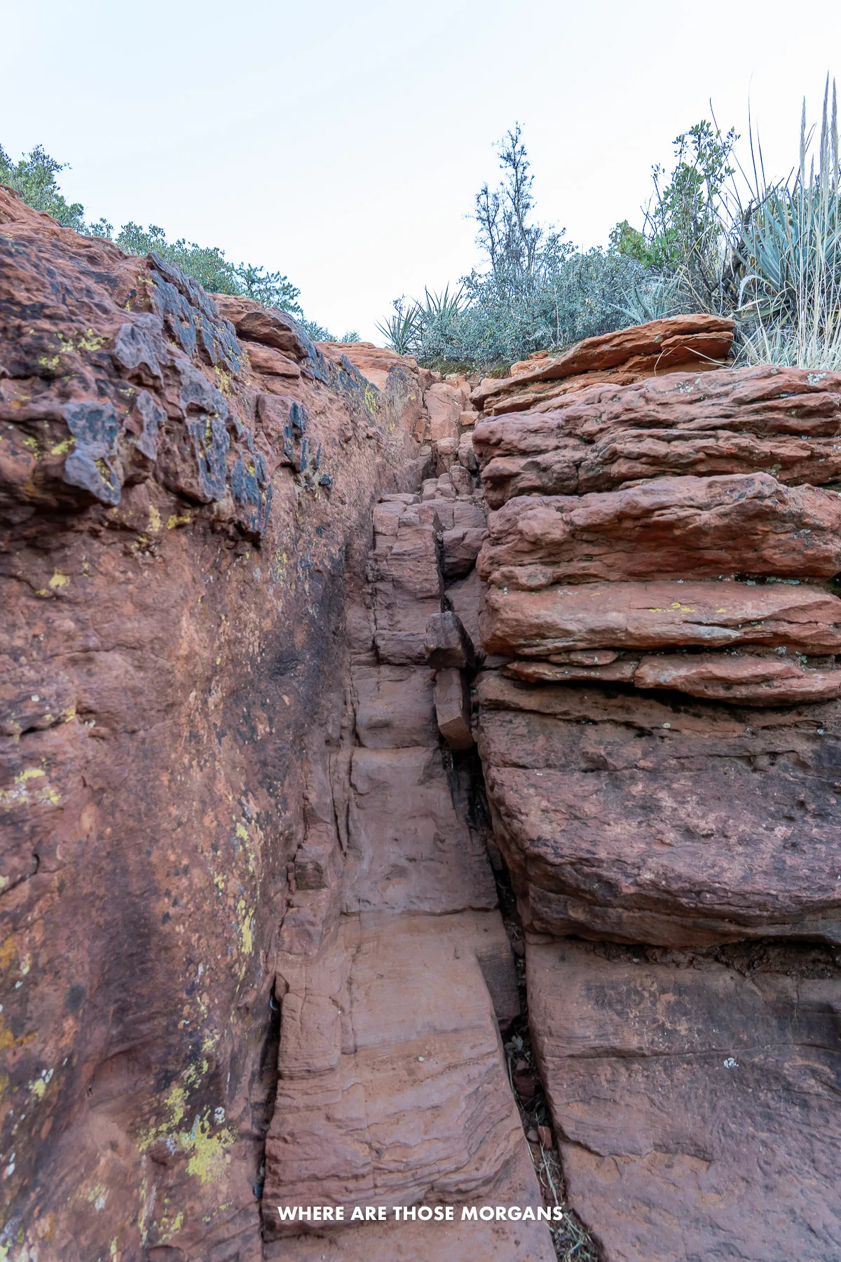 Photo of a narrow red rock scramble through uneven rocks