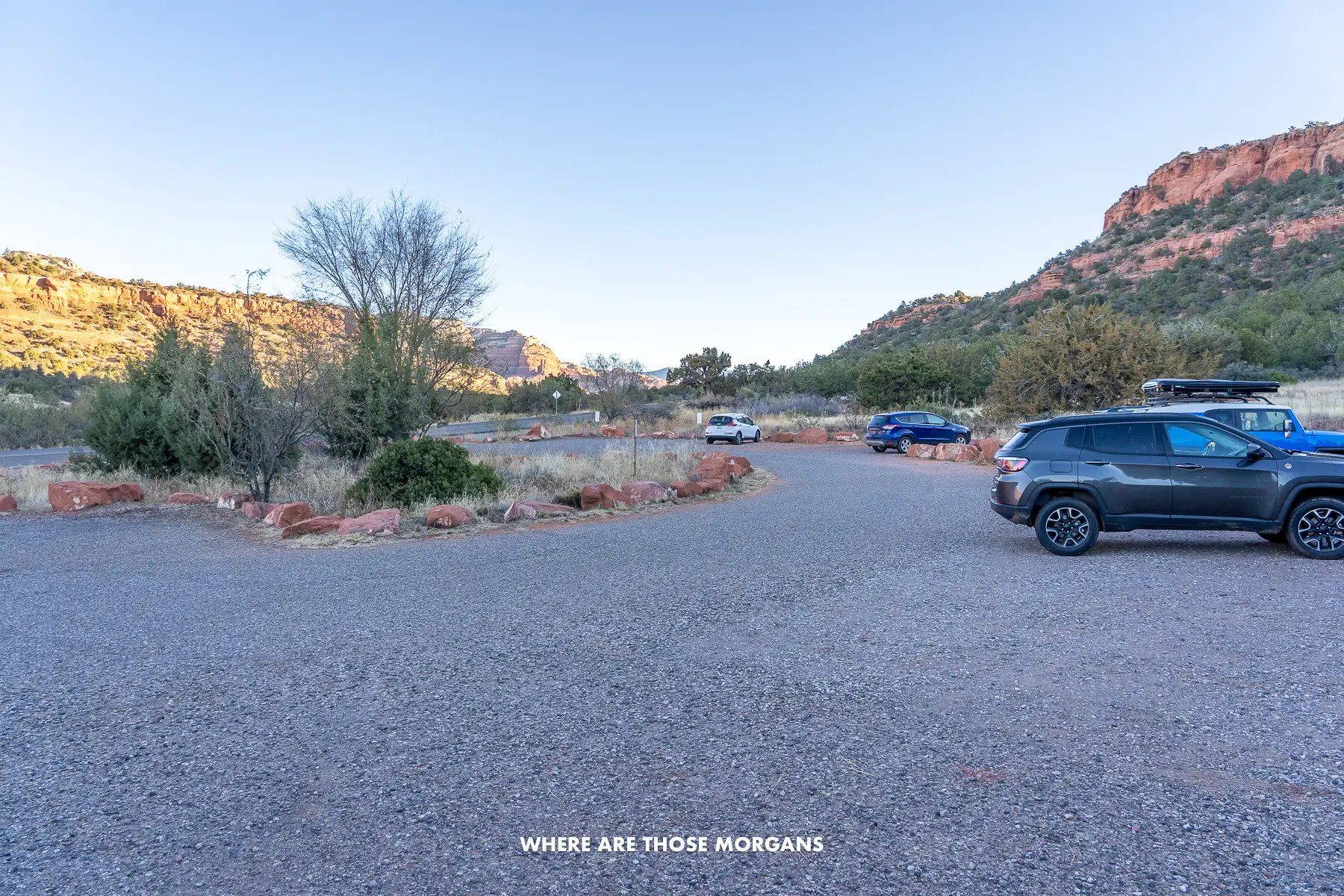 Photo of a U-shaped parking lot with a few cars parked early in the morning in Arizona