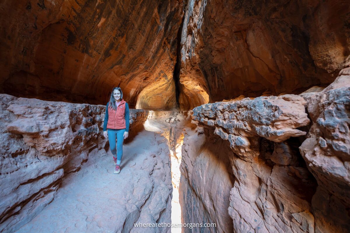 Hiker walking on a narrow ledge inside Soldier Pass Cave in Sedona