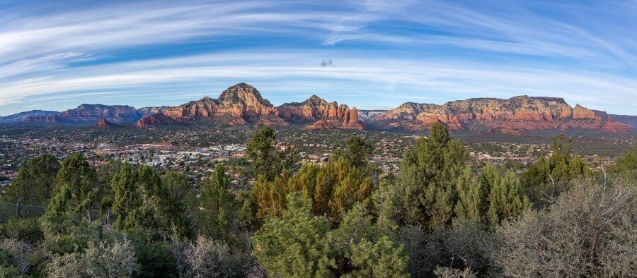 Panorama vista overlooking the city of Sedona in Arizona with red rocks background from airport mesa viewpoint on the Sedona view trail hike