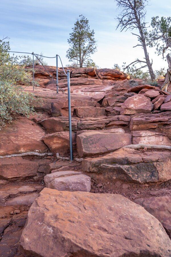 Stone steps with metal rail to ascend a short incline leading to a viewpoint in northern Arizona