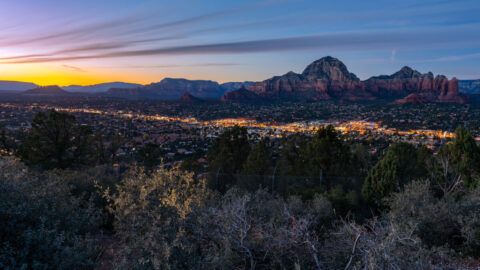 Airport Mesa Sedona View Trail hike at sunset in December stunning colors in the sky from the scenic viewpoint at dusk city lights and red rocks