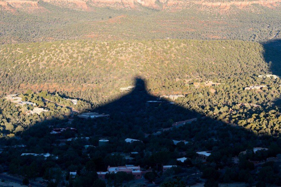 Fun photo of a rock formation in shadow creating a pyramid shape at dawn