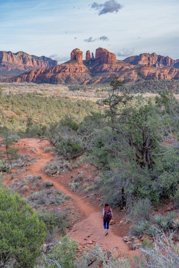 Hiker on Pyramid Scorpion Loop Trail in Sedona with Cathedral Rock in background