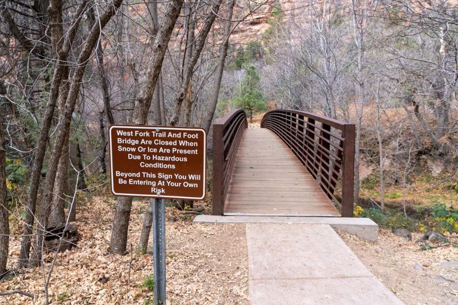 Bridge crossing Oak Creek river with information sign
