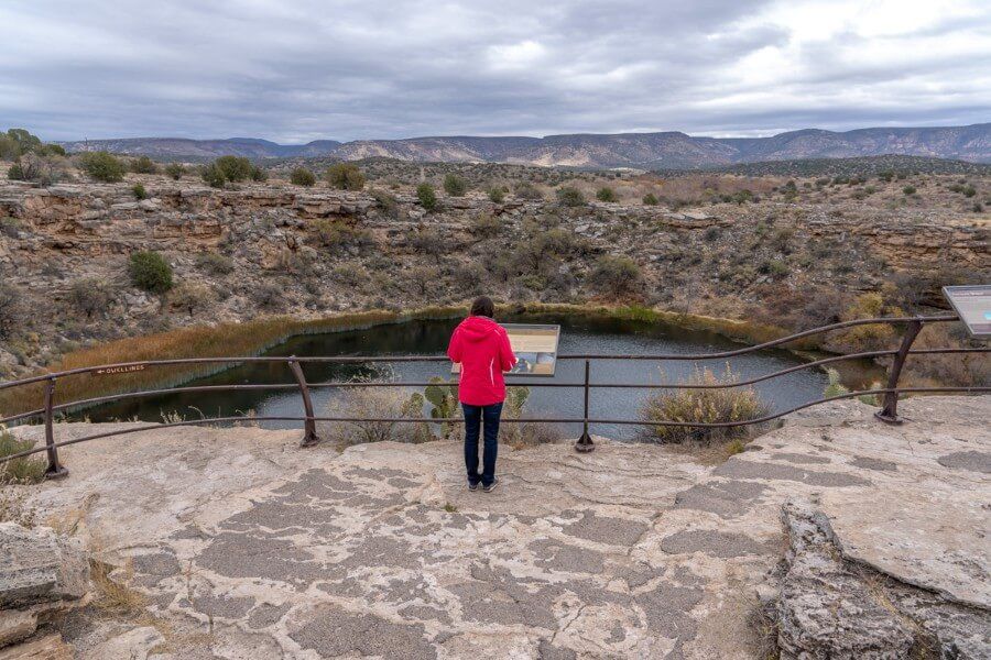 A woman reading an information sign at Montezuma Well