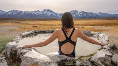 Woman soaking in hilltop hot springs