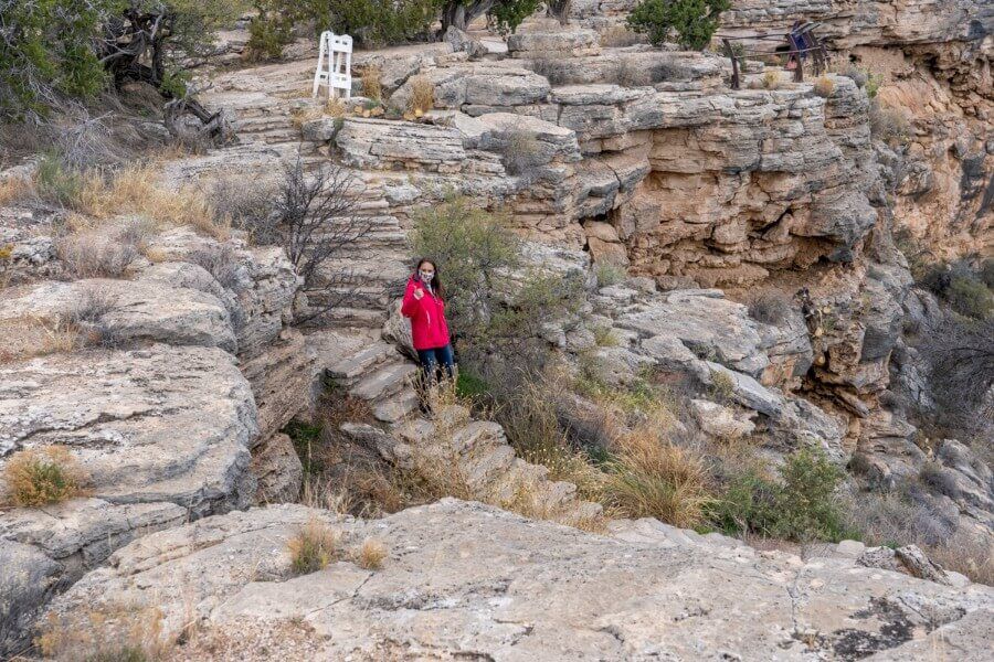 A woman hiking down to the Swallet ruins