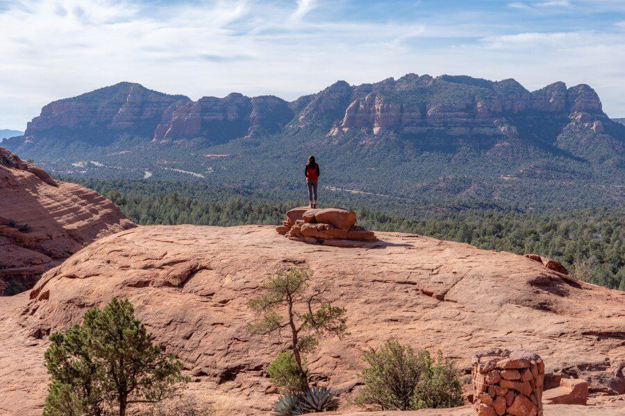 Woman stood on a rock admiring the red rock view at Chicken Point