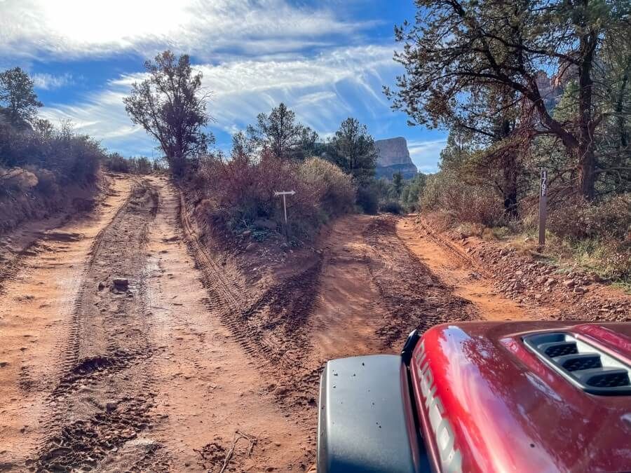 Two roads joining at a one way section driving a dirt track