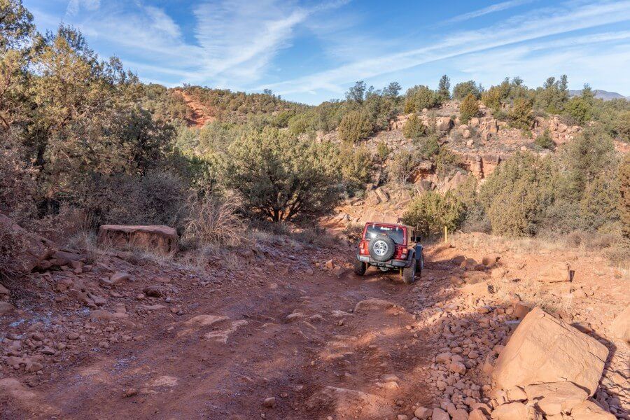 Driving a Jeep down into Diamondback Gulch off roading trail in Sedona Arizona