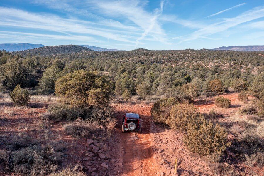 Drone photo of a Jeep driving on Diamondback Gulch off road 4WD adventure trail in Sedona Arizona