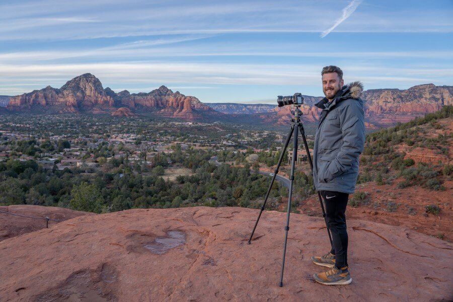 Photographer with camera on tripod in a red rock landscape in northern arizona