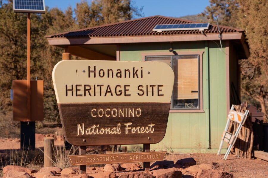 Entrance sign to Honanki Heritage Site with visitor booth in the background