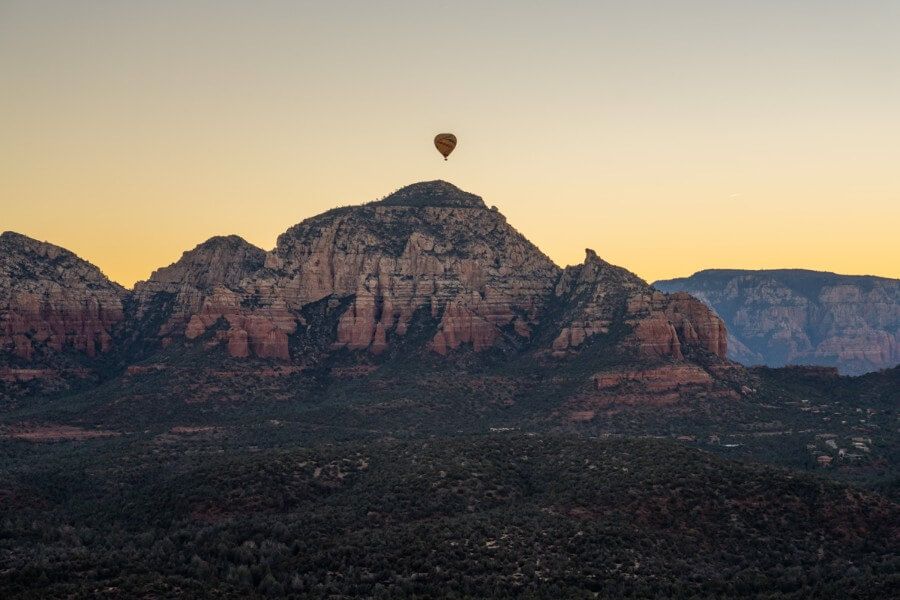 Serene yellow sky at dawn from Doe Mountain with hot air balloon in sky