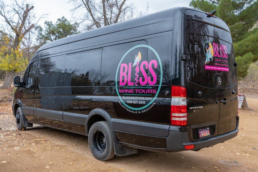 Black Bliss wine tours van in a parking lot on the Verde Valley Wine Trail