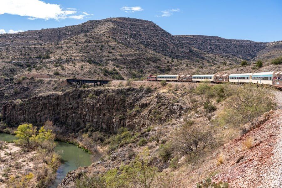 Train running along the tracks through the Verde Canyon