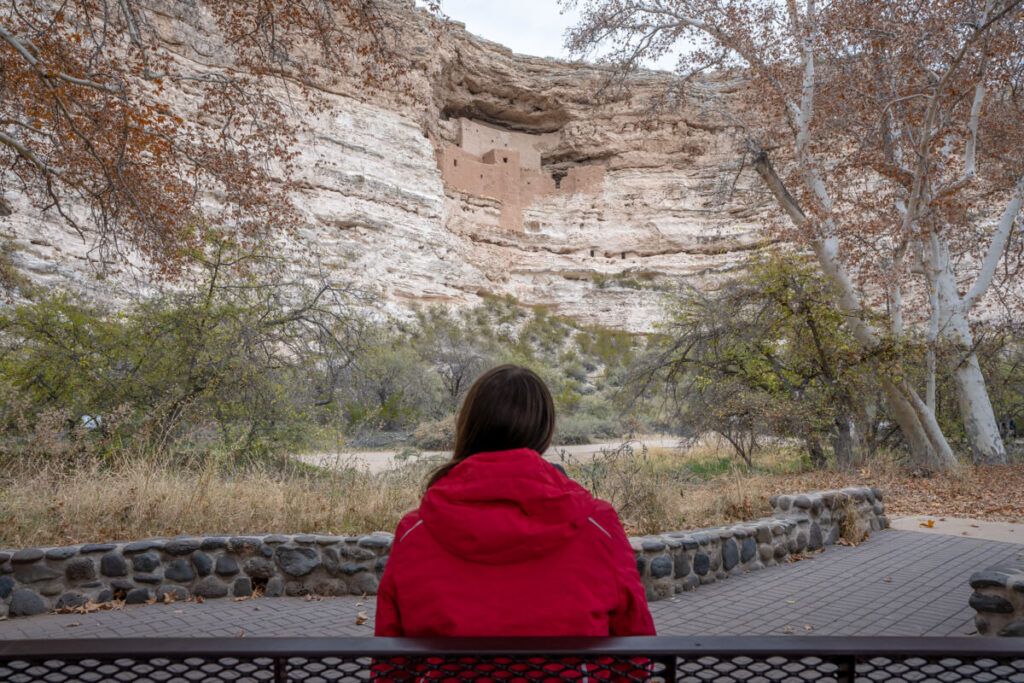 Woman looking at Montezuma Castle from a distance