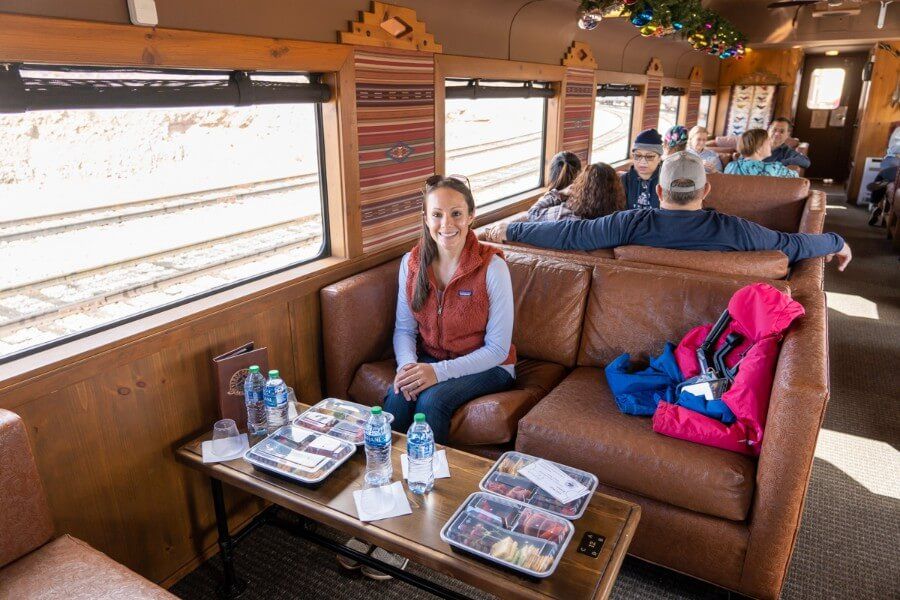 Woman sitting on a large leather couch on a rail line in Arizona