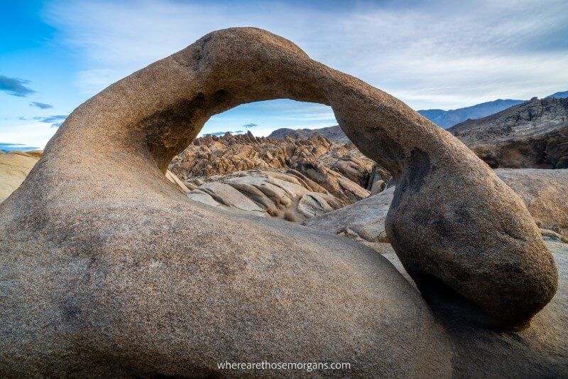 Uniquely shaped eroded arch rock formation in the Alabama Hills on a clear morning