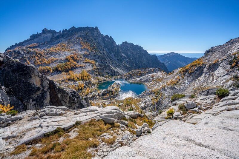 Hiking The Enchantments Trail in Washington USA during the fall season with golden larches and glacial lakes