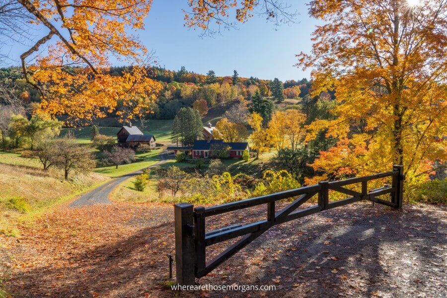 Sleepy Hollow Farm in Woodstock Vermont one of the most photographed barns in new england during fall foliage season with colorful leaves wooden fence and grassy hills