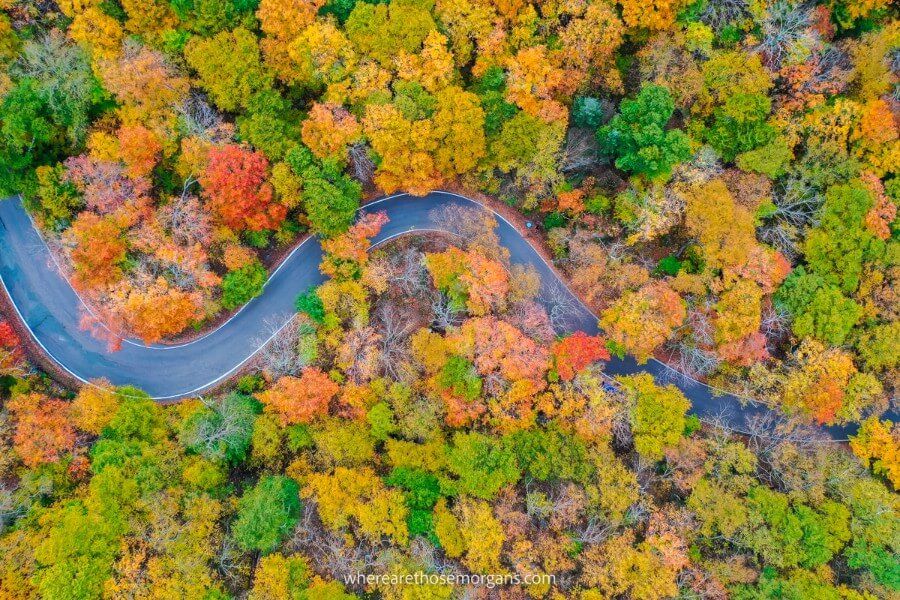 Stowe Vermont smugglers notch road from drone colorful trees in Fall make new england one of the best USA road trips