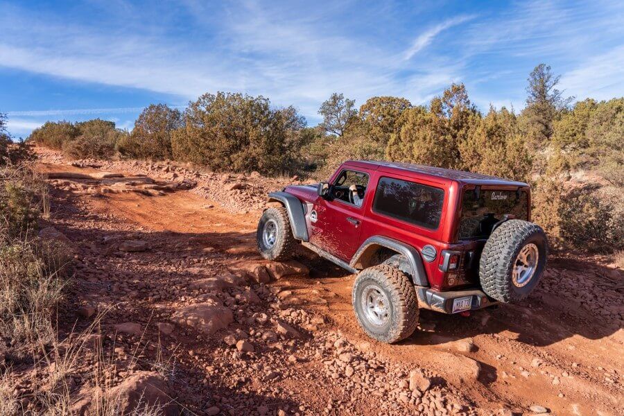Maroon Jeep Rubicon driving on Diamondback Gulch Trail in Arizona