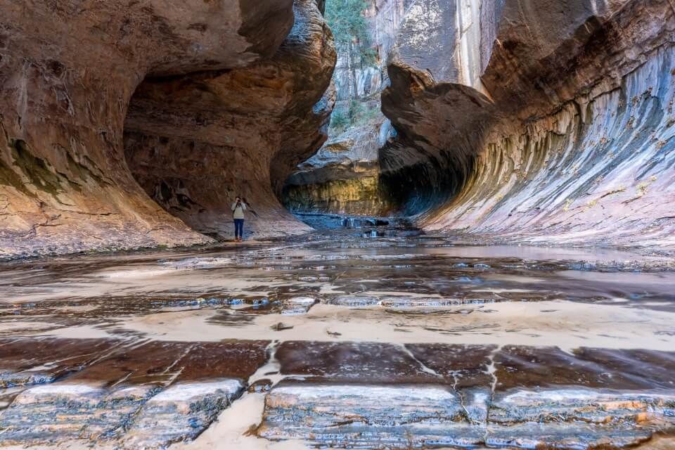 Woman hiking the subway from bottom up in Zion in the United States of America