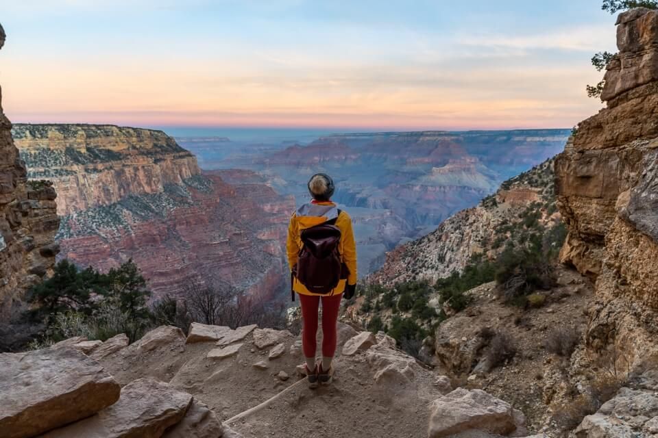 Woman standing on the South Rim of the Grand Canyon in Arizona