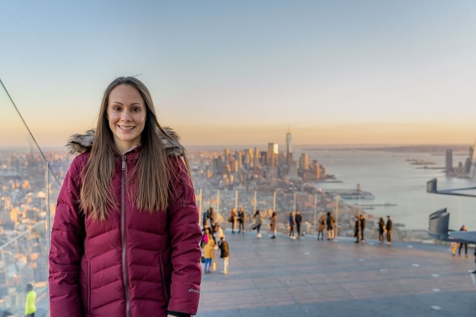 Photo of woman with Manhattan skyline behind her at Edge