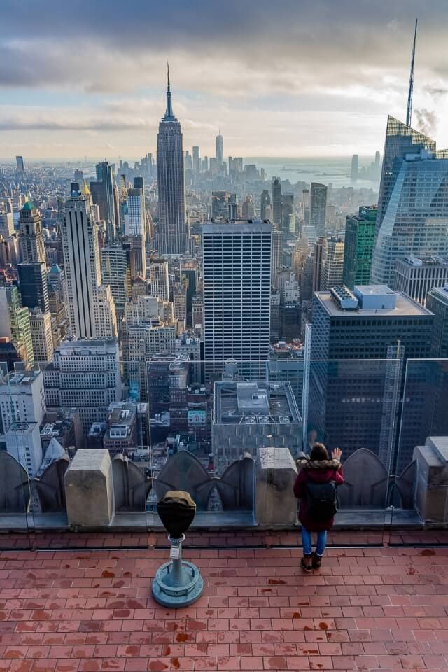 Woman looking at the Empire State Building from Top of the Rock