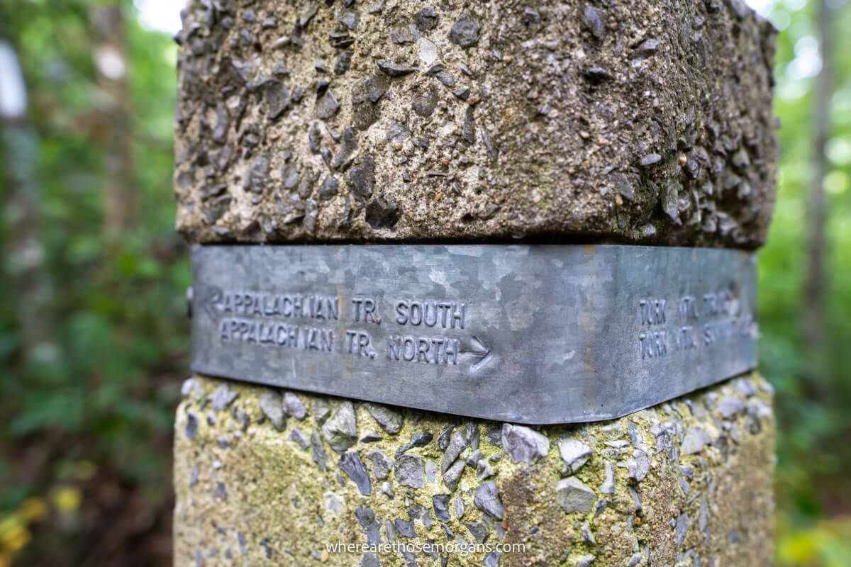 Stone post with metal sheet and engravings for the directions of hikes on the Appalachian Trail in Virginia