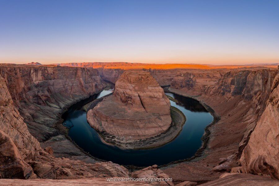 Curving Colorado River at Horseshoe Bend in Page is one of the best places to visit in Arizona at sunrise with purple sky and orange sun