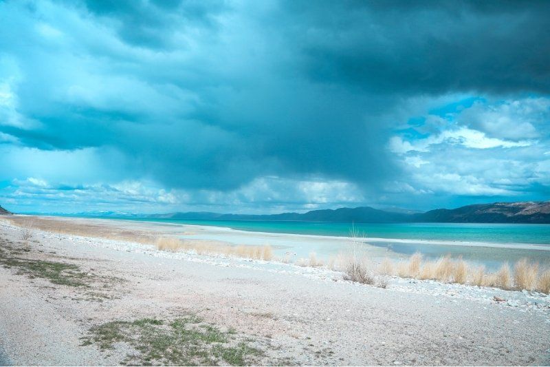 Bear Lake blue water and clouds with golden sand