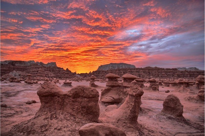Sunset colors with oddly shaped rock formations Goblin Valley State Park one of the most photogenic places to visit in Utah