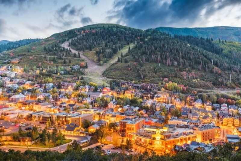 Park City Utah lit up at twilight with hill behind out of ski season