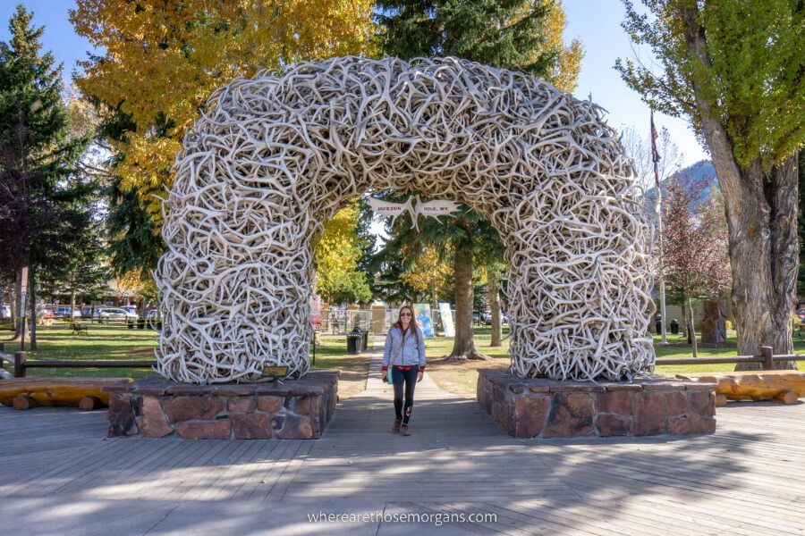 Antler arch in downtown Jackson Wyoming the best place to set up base for exploring Grand Teton with hiker stood underneath arch
