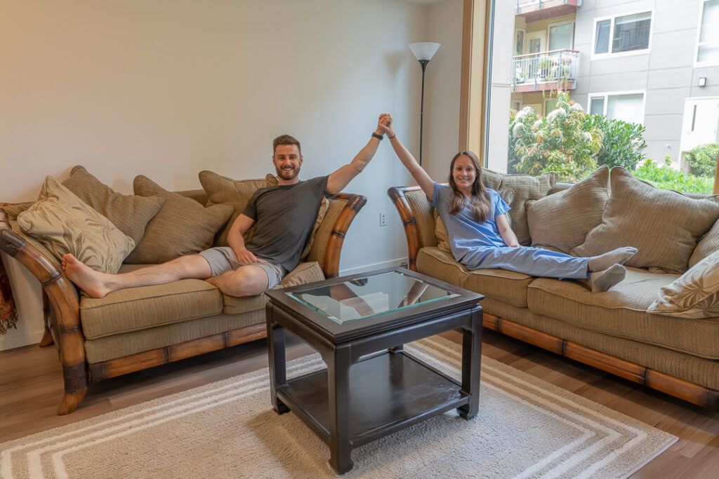 Man and woman sitting on a couch in an apartment on Lake Washington